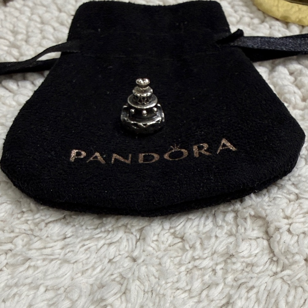 Pandora Silver Anniversary Cake Charm with heart on top layer.